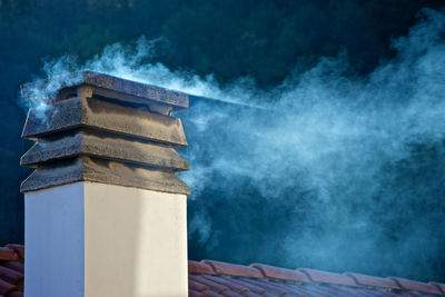 Smoke emitting from stack of building