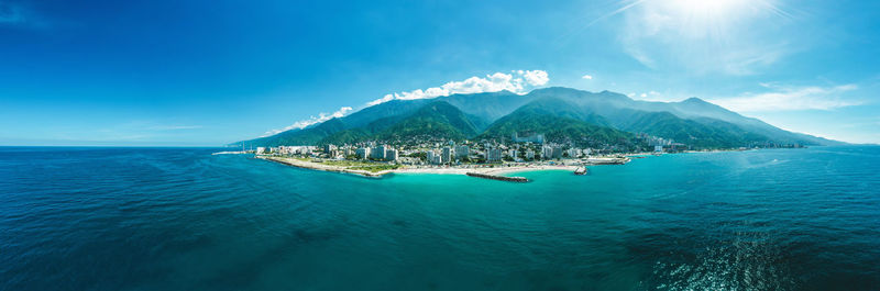 Scenic view of sea and mountains against sky