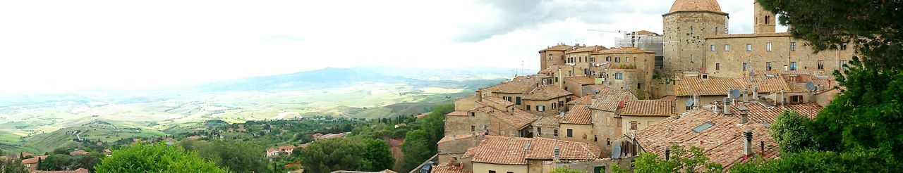 Castle on mountain against cloudy sky