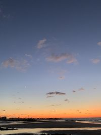 Scenic view of beach against sky during sunset