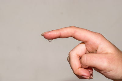 Close-up of human hand over white background