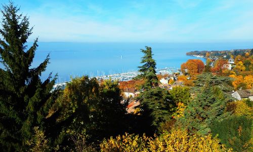 High angle view of townscape by sea against sky