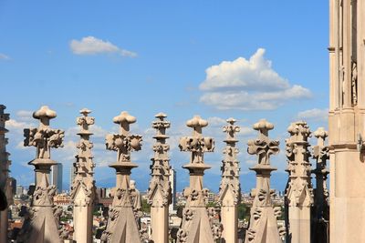 Low angle view of sculptures on building against sky