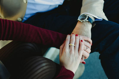 Cropped image of couple holding hands