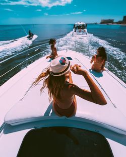 Rear view of woman on boat in sea