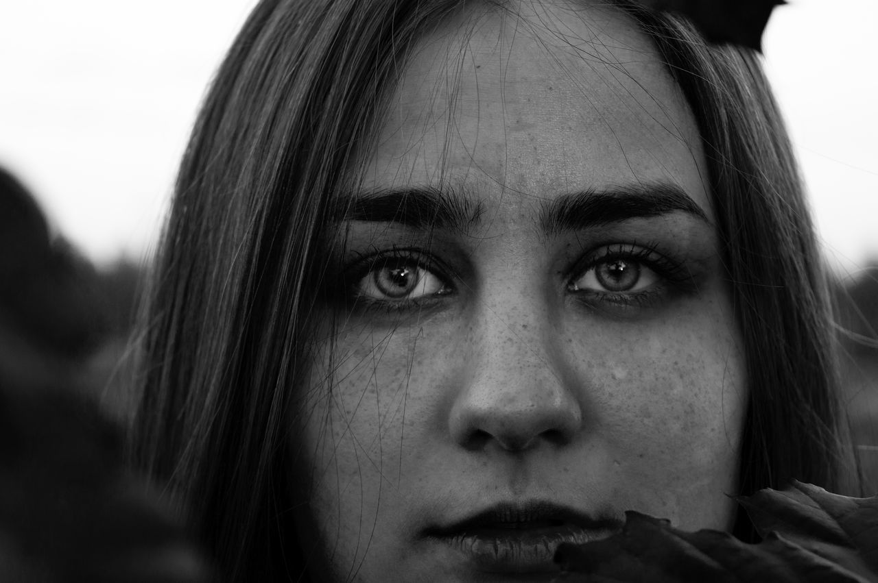 headshot, young adult, close-up, human face, looking at camera, portrait, person, lifestyles, young women, front view, head and shoulders, contemplation, leisure activity, indoors, serious, focus on foreground