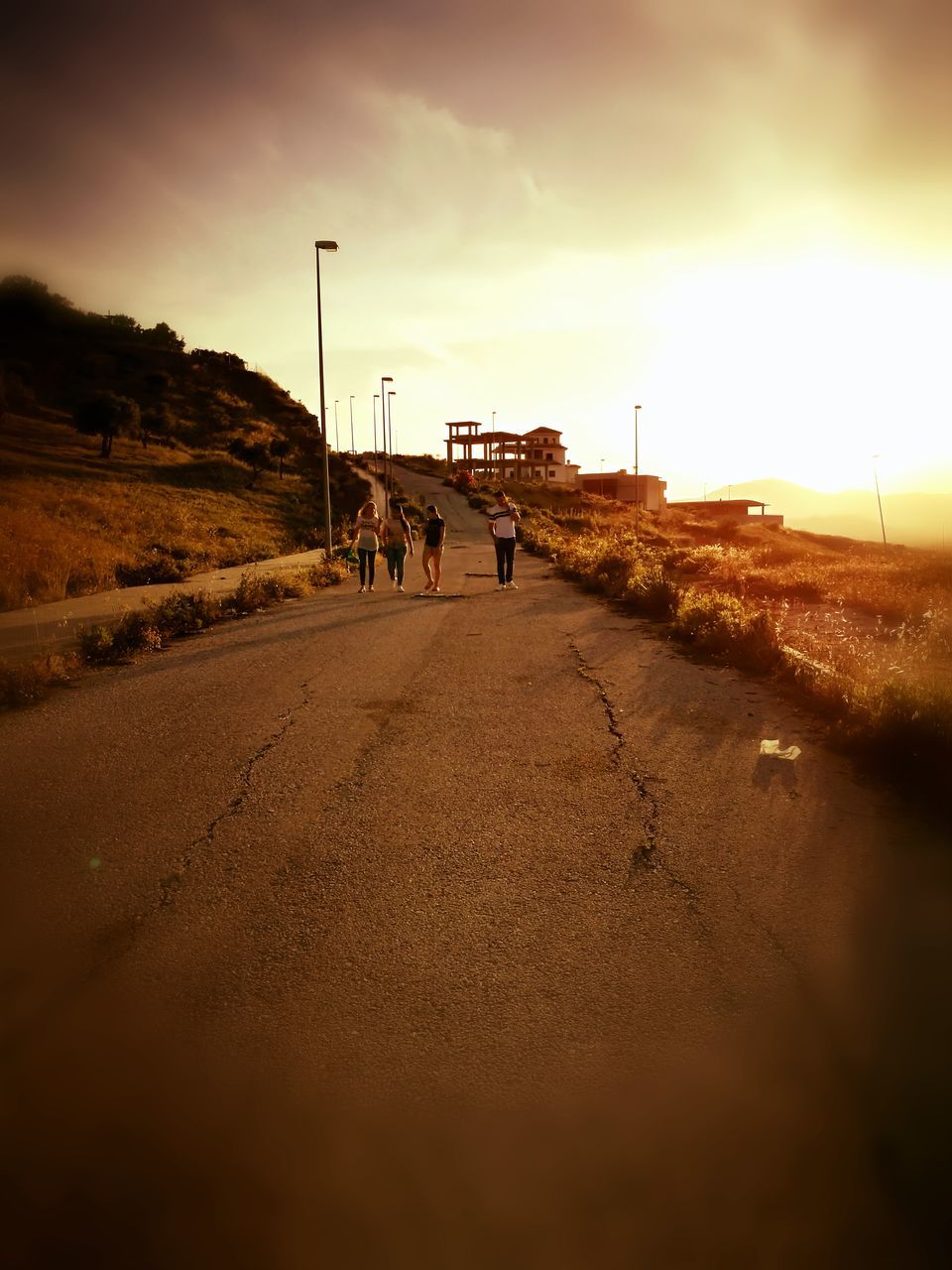 the way forward, road, sky, real people, walking, sunset, men, transportation, outdoors, nature, women, day, one person, people