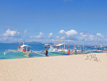 Scenic view of beach against blue sky