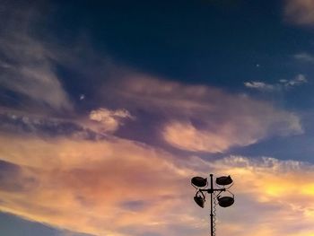 Low angle view of silhouette crane against sky during sunset