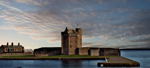 Historic building against sky during sunset