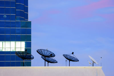 Low angle view of modern building against blue sky