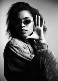 Portrait of young woman against gray background