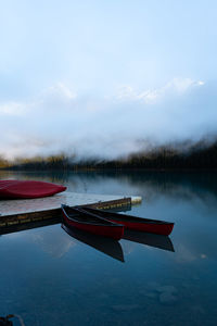 Scenic view of boats on a lake against sky