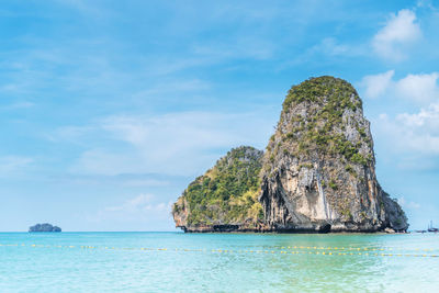 Rock formation in sea against sky