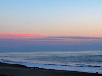 Scenic view of beach against sky during sunset