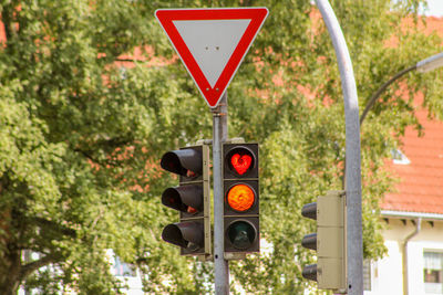 Road signals against trees in city