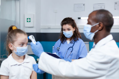 Doctor examining girl at clinic