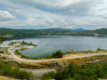 Mining quarry with flooded bottom. lake with blue water near sand pit. sipalay, negros, philippines.