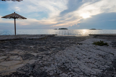 Scenic view of beach against sky during sunset