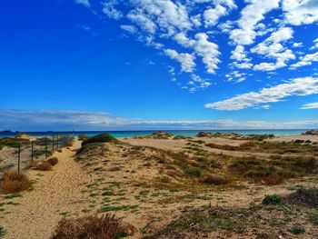 Scenic view of land against blue sky