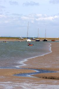 Sailboats on sea against sky
