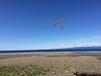 Scenic view of beach against blue sky