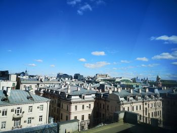 High angle view of buildings against blue sky