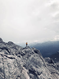 Full length of man on rocks against mountain