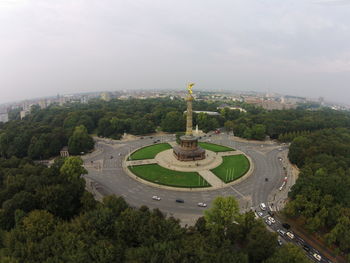 Aerial view of city against cloudy sky