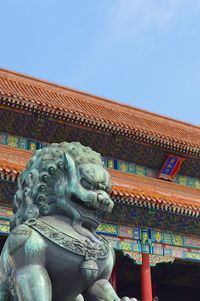 Low angle view of statue against building