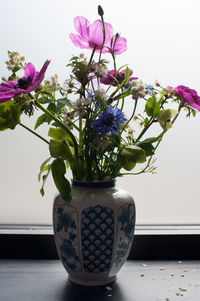 Close-up of flower vase on window sill