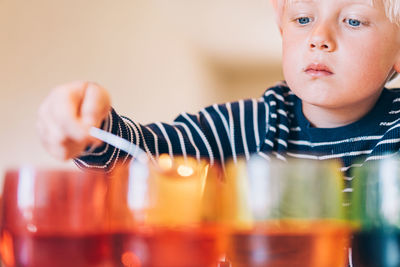 Young boy dying easter eggs