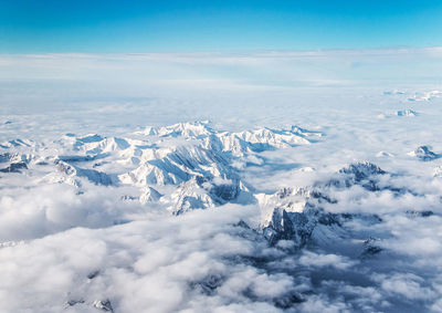 Aerial view of snowcapped mountain against sky