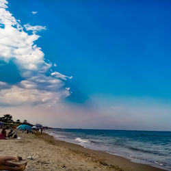 Scenic view of beach against blue sky
