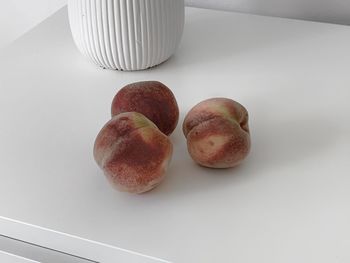 High angle view of apple on white table