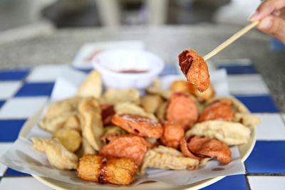 Close-up of person preparing food on table