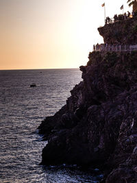 Scenic view of sea against clear sky at sunset