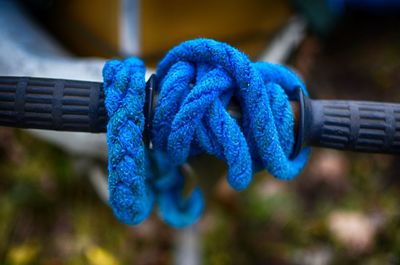 Close-up of blue ropes tied to handle