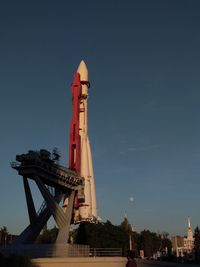 Low angle view of rocket on building against sky