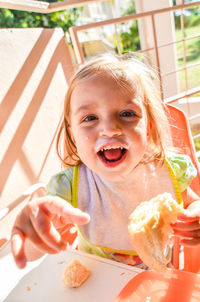 Portrait of messy cute girl having food