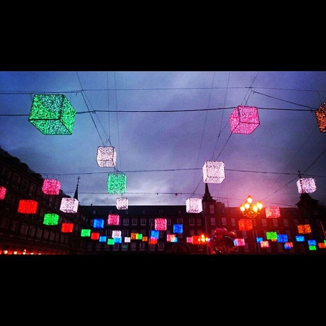 LOW ANGLE VIEW OF ILLUMINATED LIGHTS AT NIGHT