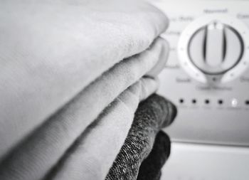 Close-up of clothes stacked indoors