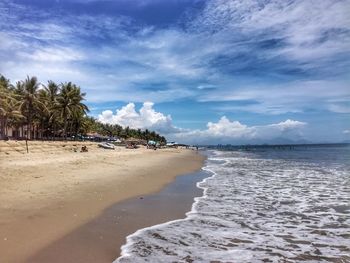 View of beach against cloudy sky