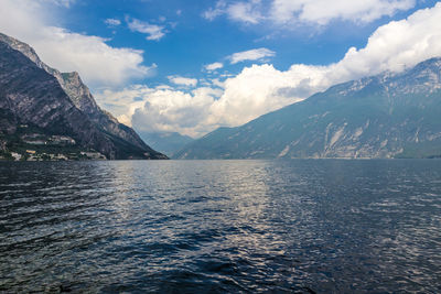 Scenic view of sea and mountains against sky