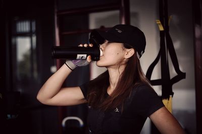 Midsection of woman holding hat