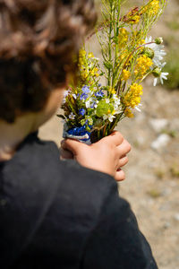 Boy picks flowers for mom