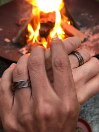 Close-up of hands holding candles