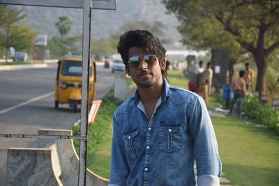 Portrait of young man standing on bus