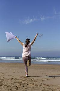 Full length of woman walking on beach