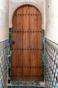 Closed arabesque door in the palace of the alhambra in granada, spain